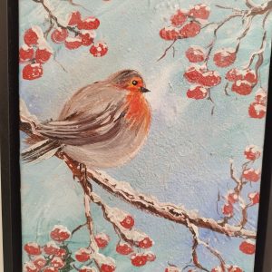 Robin on a snowy branch